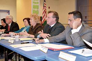 Sitting School Committee members, as well as Mayor Curtatone, listened as the finalists presented their cases for appointment to the vacant seat.~Photo by Harry Kane