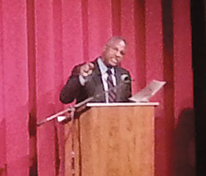 Mr. Clennon King reads Dr. King's speech at the Somerville Theatre on Monday. ~Photo by By Emmanuel Vincent.