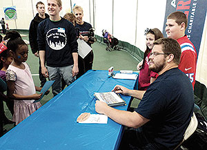 New England Patriots Center Ryan Wendell signed autographs read to kids at “Read by the River” Carnival at the Tufts Gancher Center last Sunday. ~Photo by Terence Clarey