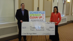 Deputy Director of Communications for the City of Somerville, Jackie Rossetti (right) presents Somerville resident Thomas Barton with a $250 prize for his winning design of the new Somerville Spring Cleanup logo.   