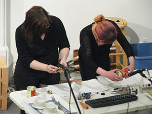 Austen Wright (left) and Natasha Mogilevskaya (right) perform Foley effects. ~Photo by Jay Sekora