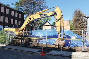 Demolition at the site of last Thursday’s fire has already begun. ~Photo by Harry Kane.